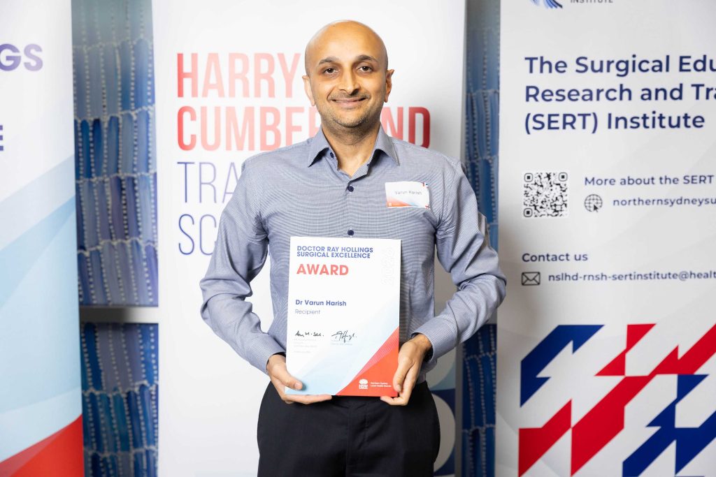 Dr Varun Harish holding Dr Ray Hollings Surgical Excellence Award certificate Sydney (2026)